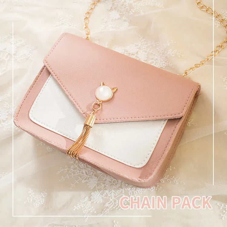Small square PU leather crossbody bag with cat tassel decoration, magnetic flap, and adjustable chain strap in black
