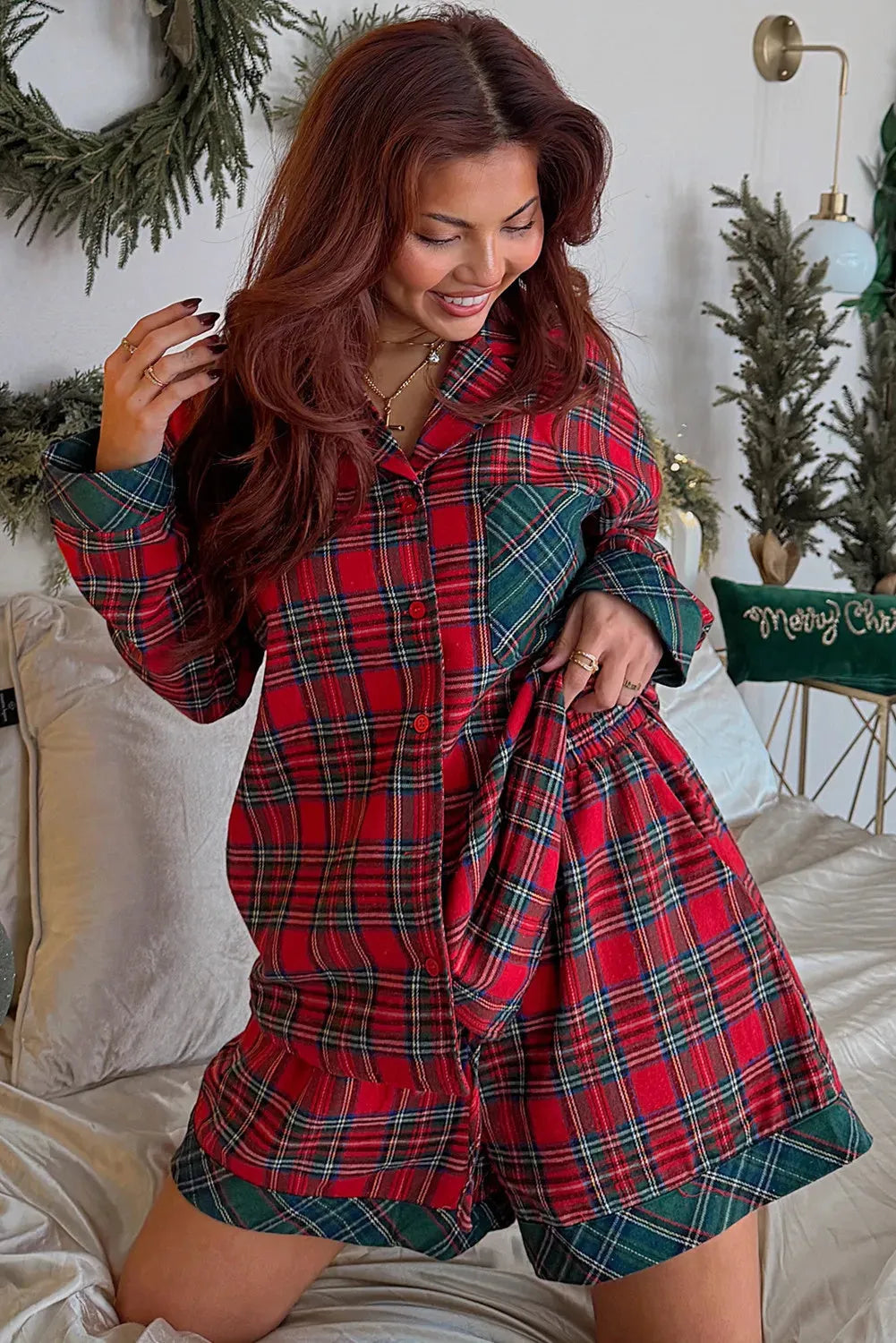 Red plaid two-piece pajama set with long sleeve shirt and shorts featuring contrast patches.