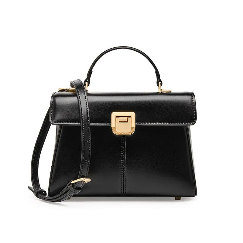 Women's black leather shoulder bag with a vachette clasp, showing its horizontal square shape and adjustable strap.