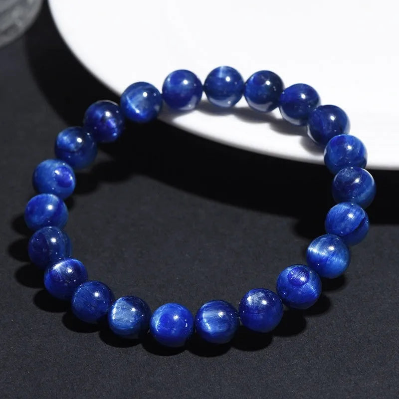 Polished blue crystal bracelet with geometric beads and Ruyi charm, shown in trade fair gifting context