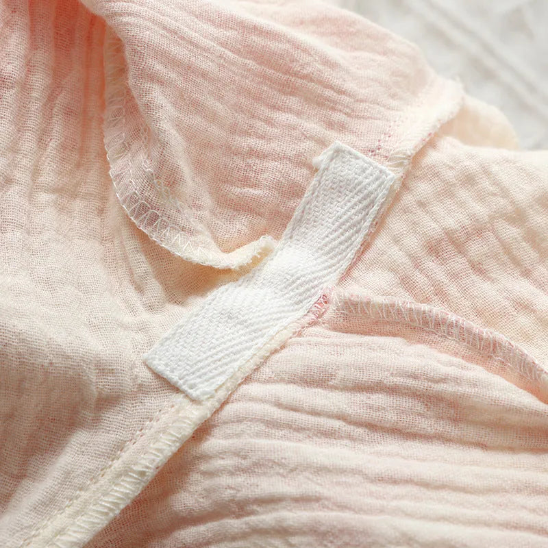 Women's pink pure cotton gauze lounge suit with lace-up detail and long sleeves, shown with matching trousers