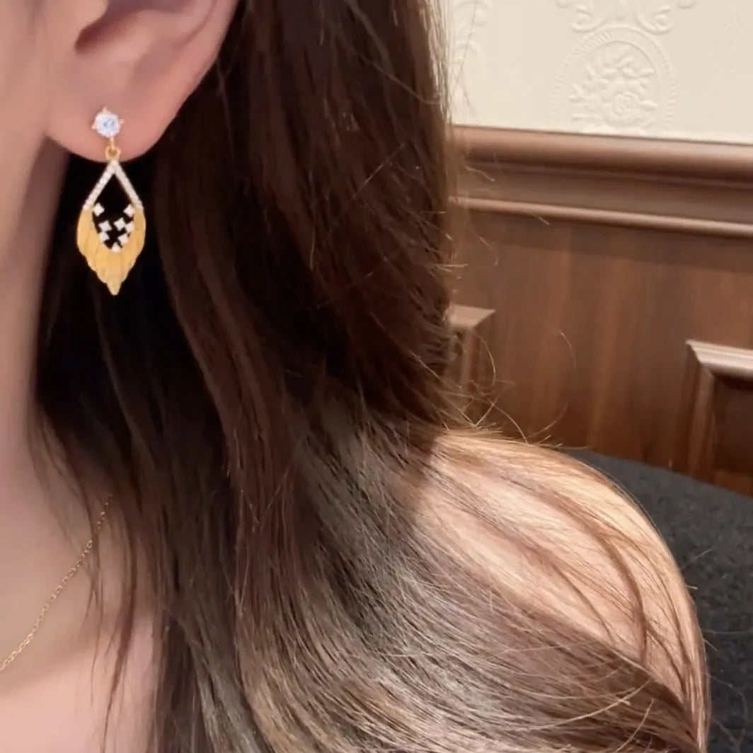 925 sterling silver brushed spot drill feather stud earrings in white gold colour on ear