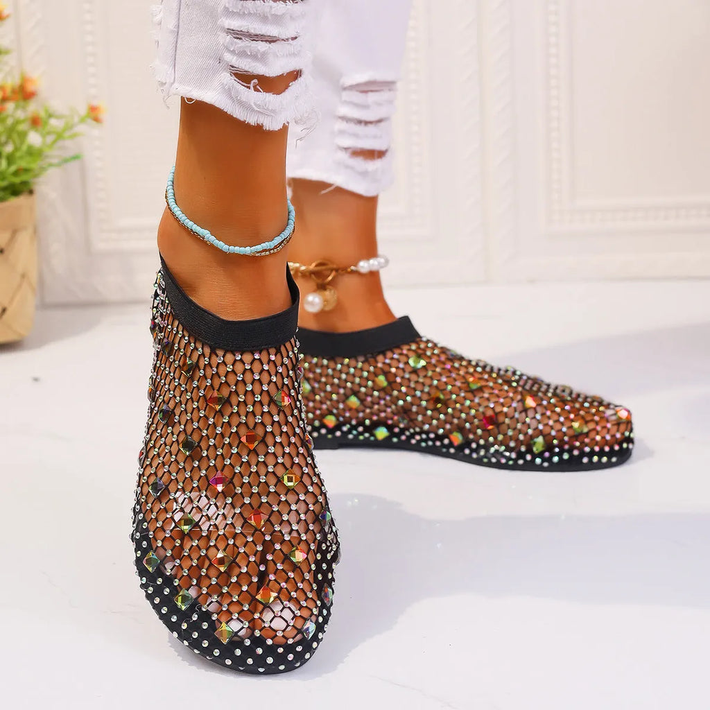 Women's flat sandals with mesh upper, colourful rhinestone design, and round toe on a rubber sole.