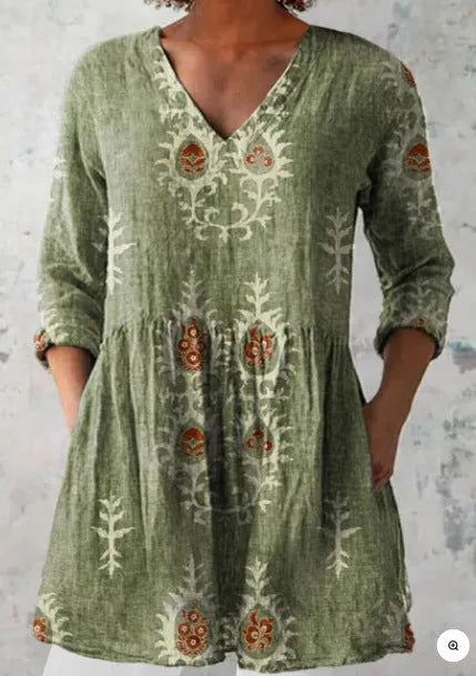 Women's loose floral print dress with wide waist and 3/4 length wave-pattern sleeves.