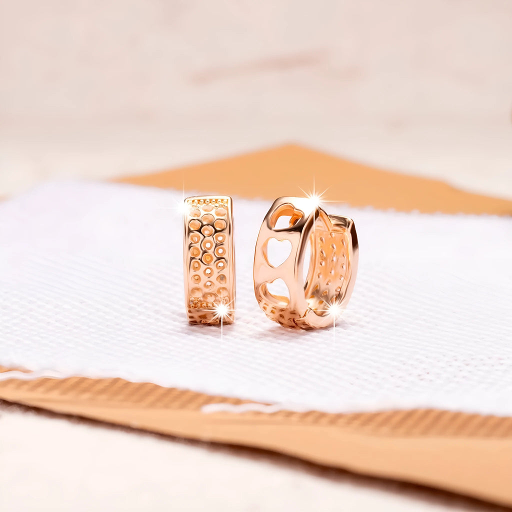 A pair of circular rose gold women's earrings with a three-heart hollowed-out design.
