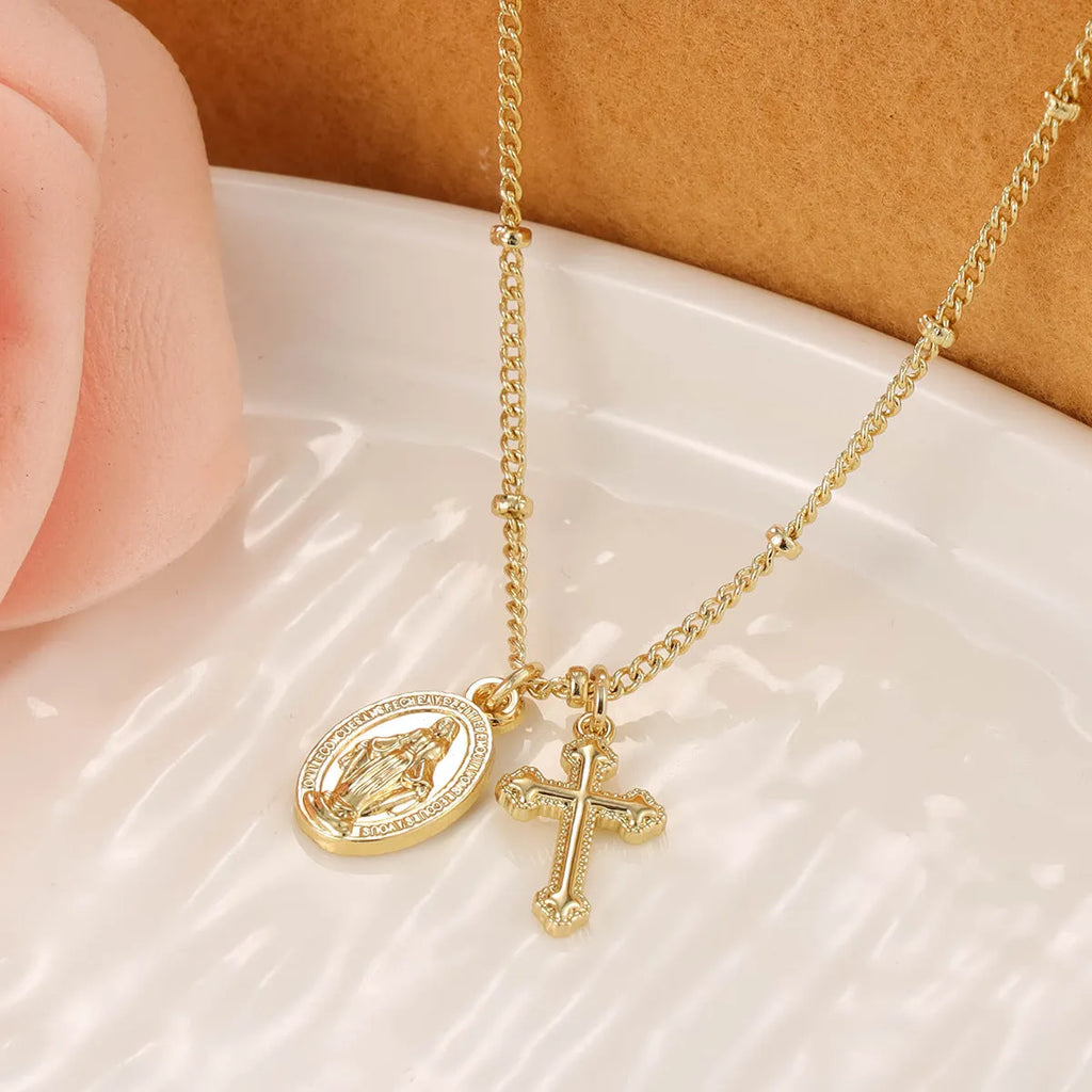 Gold coloured geometric cross necklace with a Virgin Mary ornament pendant for women.
