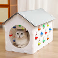 Plastic house-shaped cat scratch board integrated with a cat nest, tunnel, and bell ball toy.