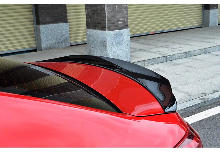 Bright black modified tail trim for Mazda 3 Exela 2014-2021 models showing large fixed wind surround design