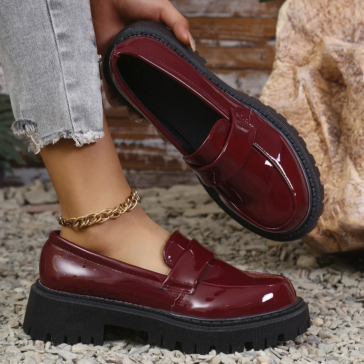 Plus size women's black slip-on loafers with a chunky platform heel and thick rubber sole.