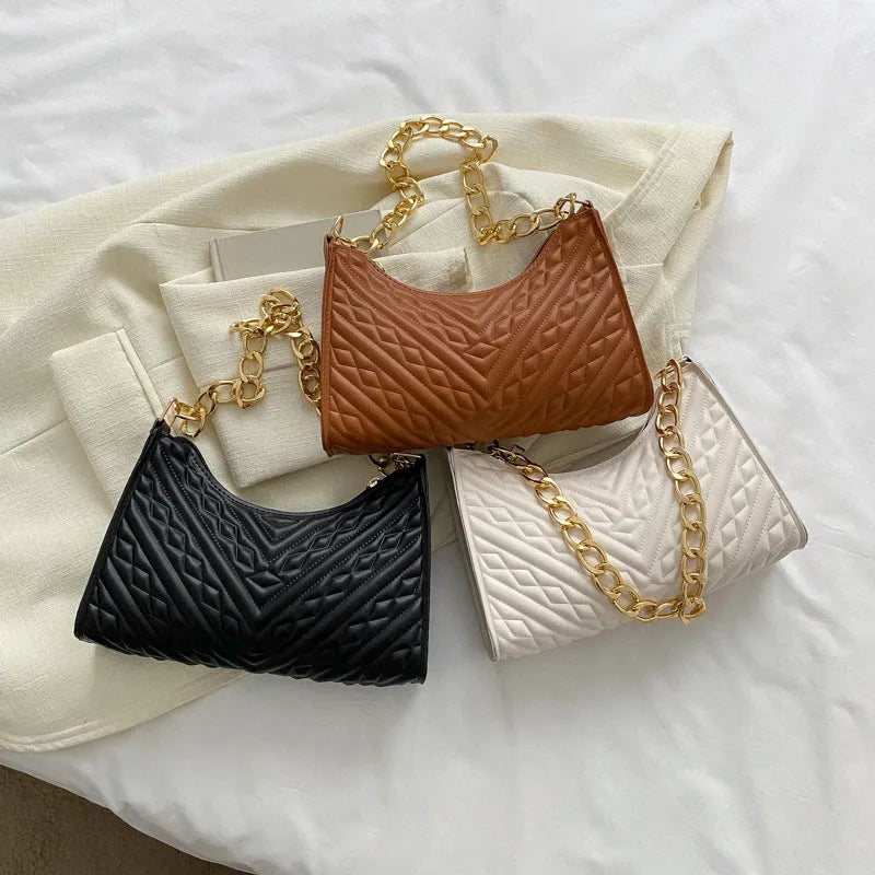 Brown pleated PU baguette shoulder bag showing its vertical square shape and chain strap.