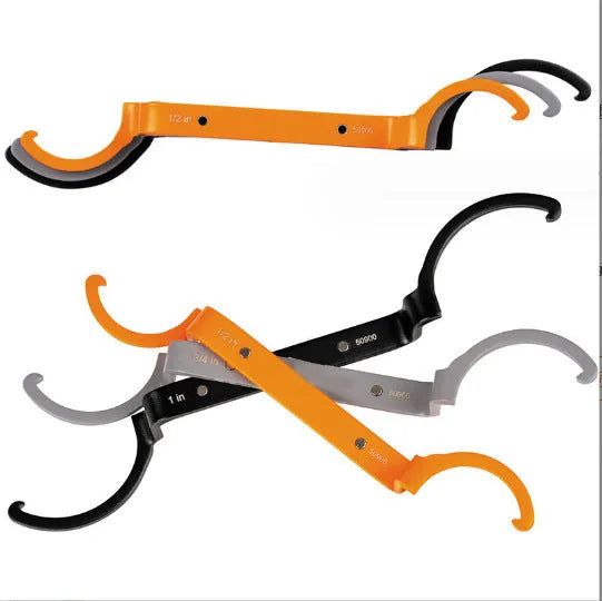 Three-piece spanner set showing orange, grey, and black wrenches with magnetic suction and catheter locking functions