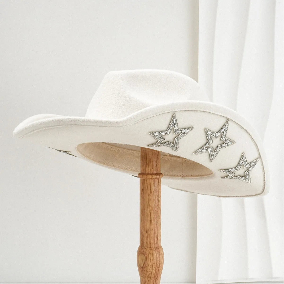 A beige woven polyester Western-style top hat with a conical crown and a hexagonal star detail on the front.