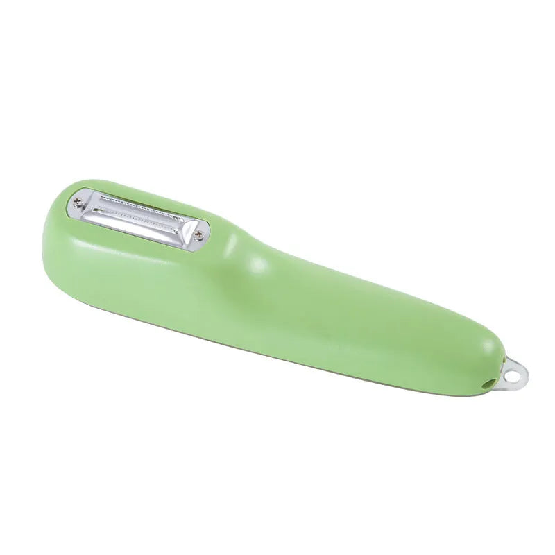 Dark green vegetable peeler with stainless steel blade inside its clear storage tube on a kitchen counter.