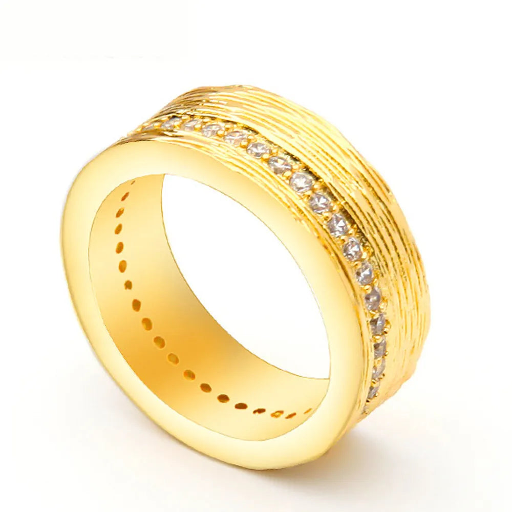 Gold geometric women's zircon ring made from electroplated copper on a grey background.