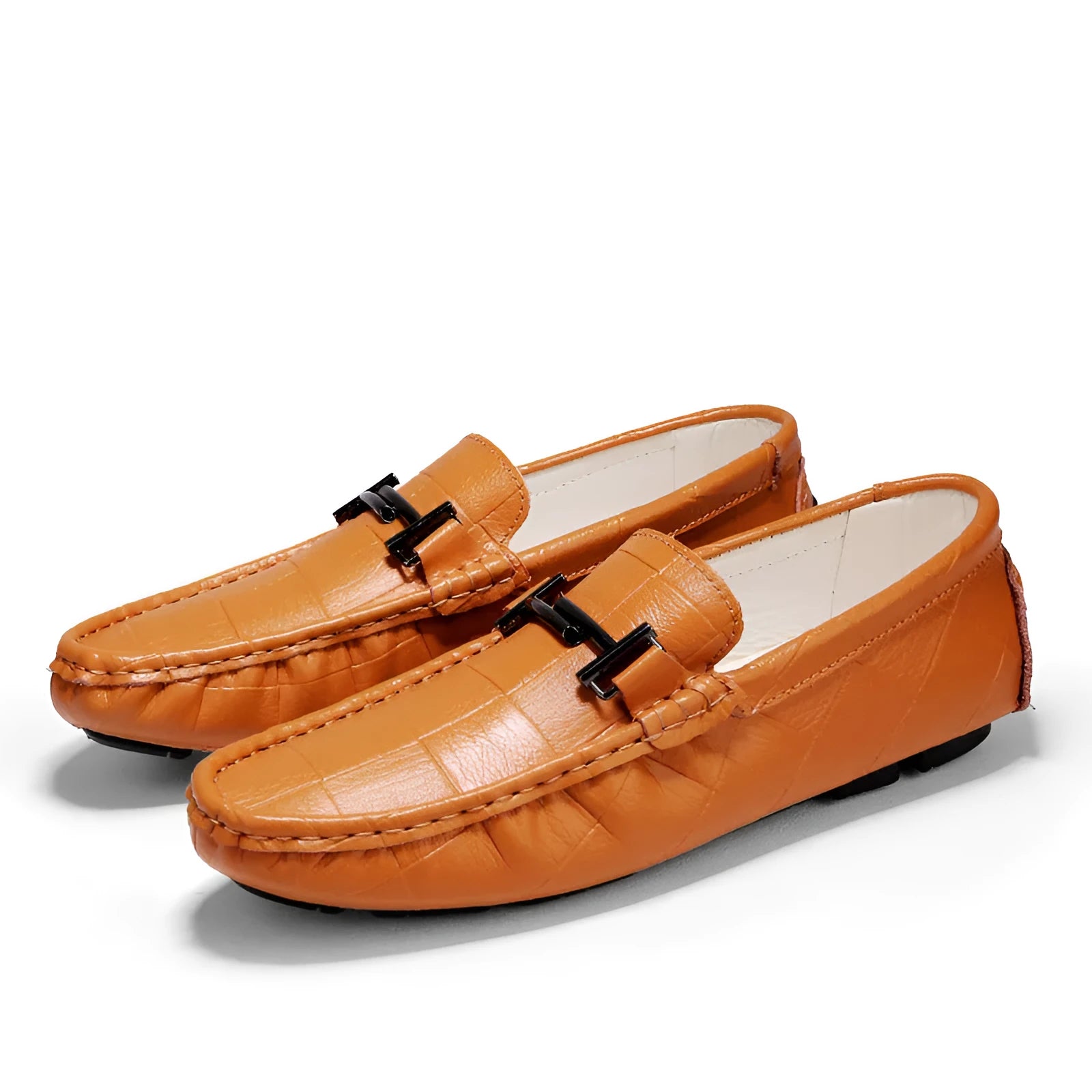 Men's brown leather loafers with silver buckle detail on low-cut design