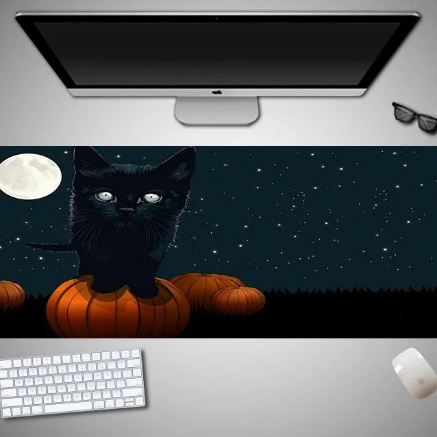 Oversized Halloween-themed rubber cloth gaming mouse pad on a desk.