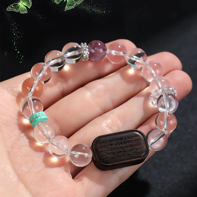 Handmade natural white crystal ebony bracelet with five warp design on wooden background
