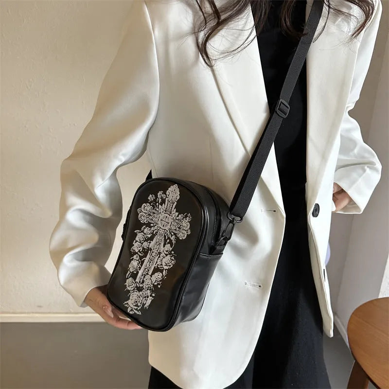 Black Halloween-themed mini crossbody bag with cartoon pumpkin, ghost, and bat prints.