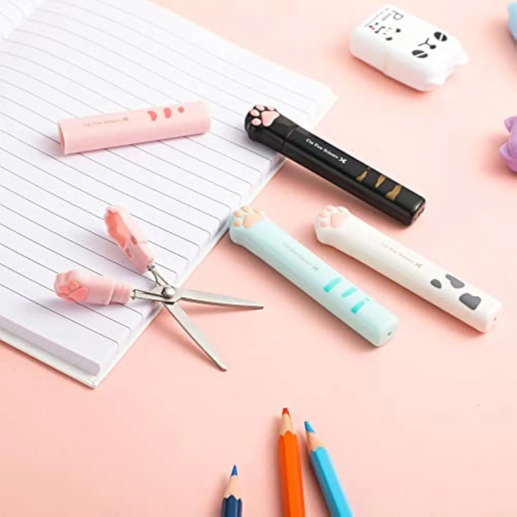 Set of four mini folding scissors with cat paw handles in pink, white, black, and blue colours, shown closed.