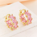 Geometric U-shaped gold earrings with a round black crystal zircon stone.