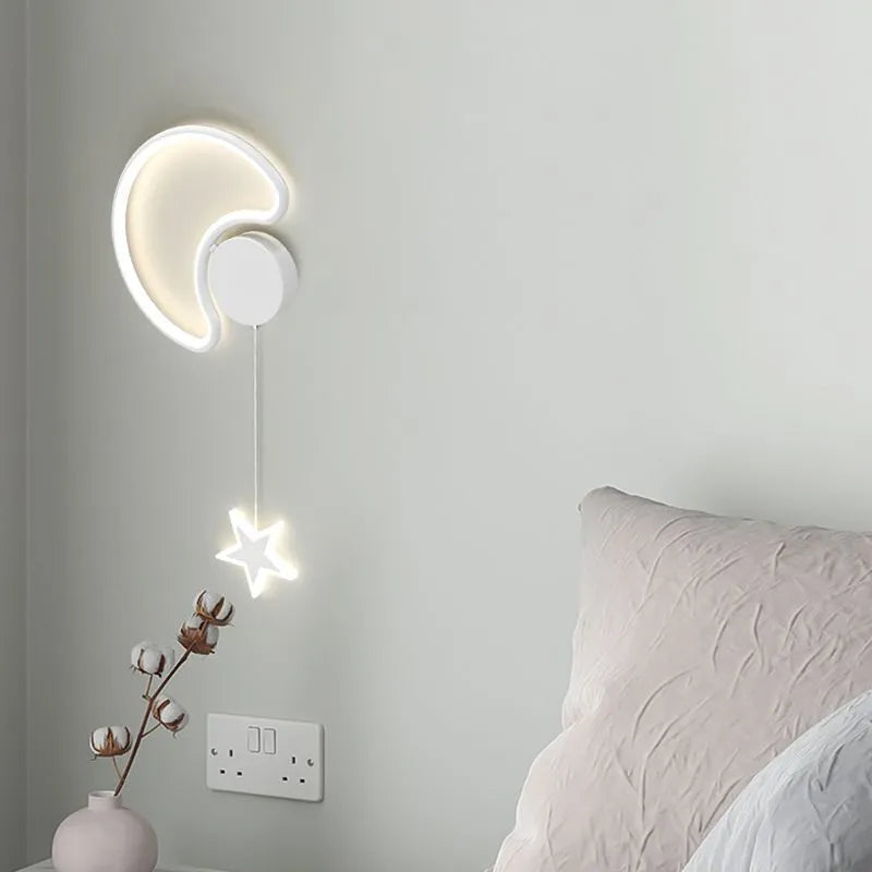 White left-facing cloud children's bedside wall lamp with a three-colour LED light on a bedroom wall.