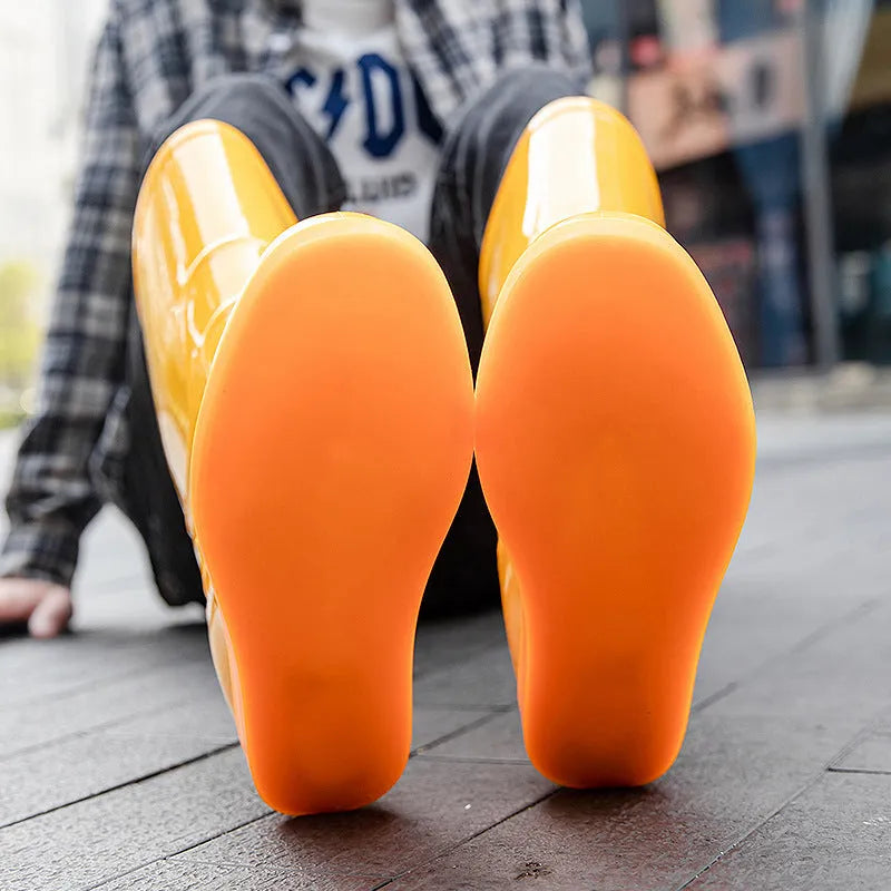 Plastic washable rain boots in white or yellow colours with high tube design and flat heel