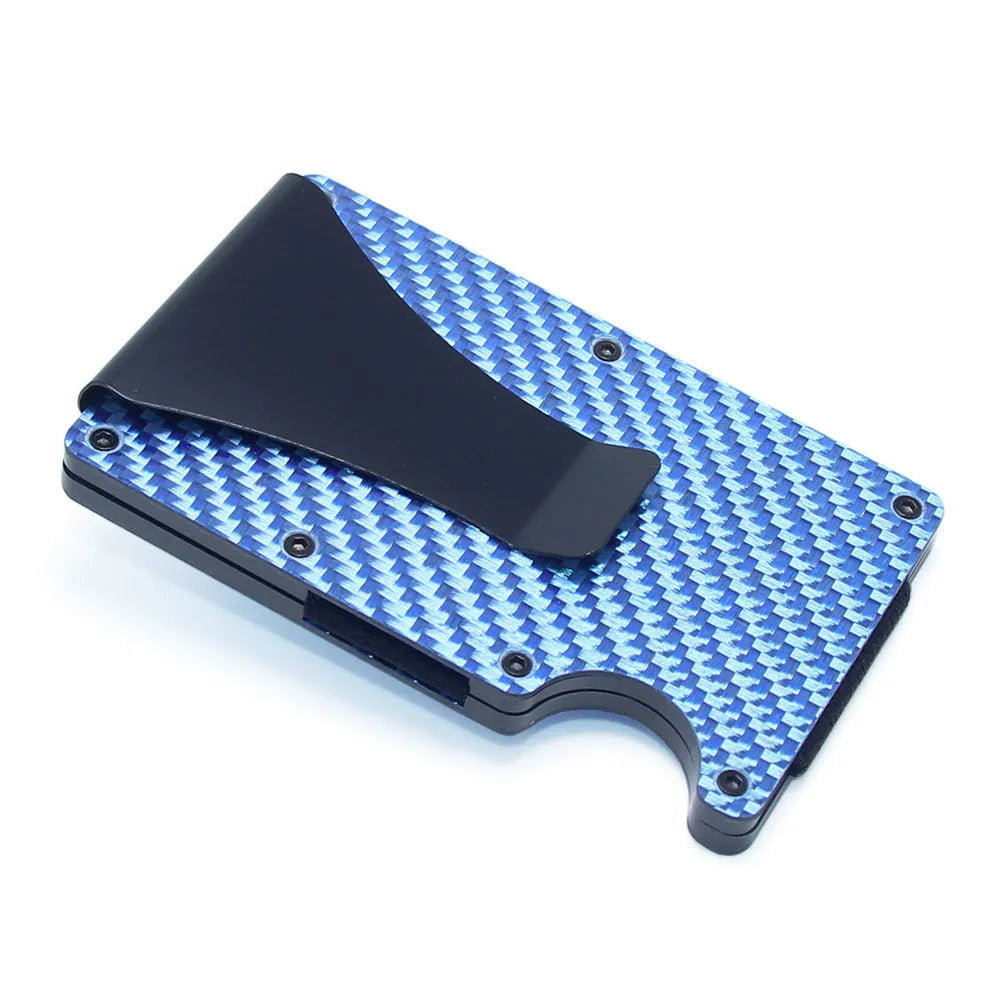 Geometric carbon fibre and aluminium business card holder, 8mm thick, on a table.