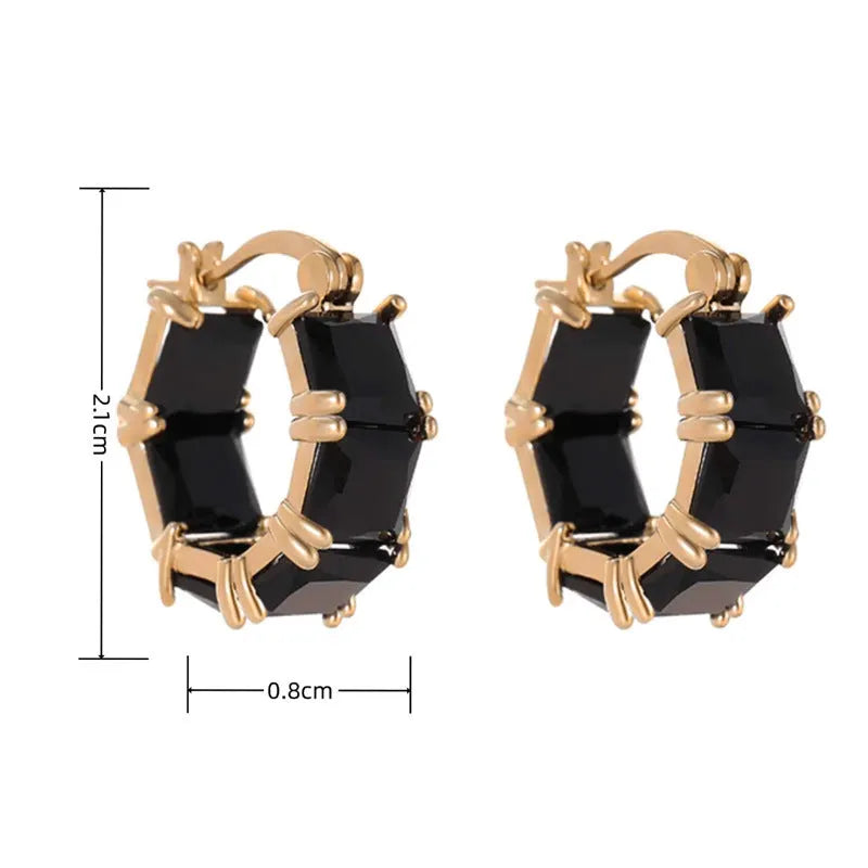 Geometric U-shaped gold earrings with a round black crystal zircon stone.