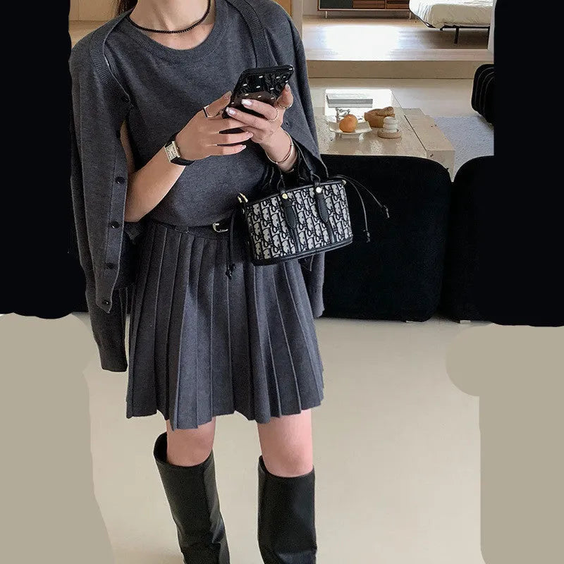 Women's grey art retro knitted cardigan and pleated vest skirt set with a belt.