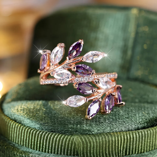 Adjustable copper leaf design ring with sparkling zircon stones on a model's finger.