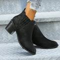 Black pointed toe women's ankle boots with a thick square low heel on a white background.