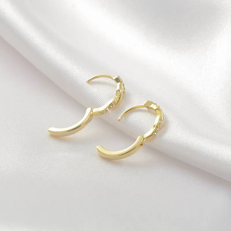 Geometric interwoven hemp rope earclip earrings in gold or silver colour on a copper base.