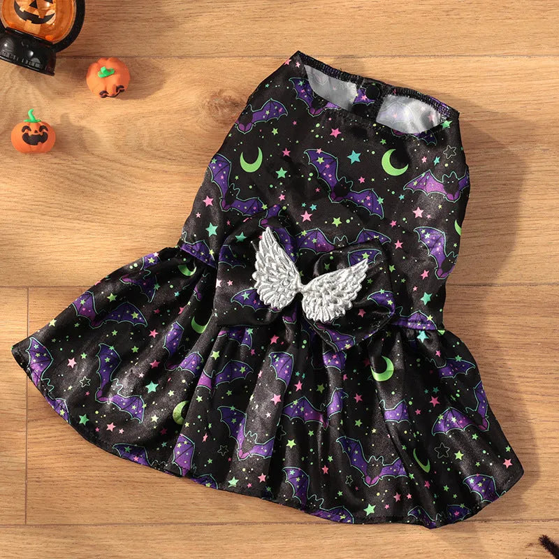 Angel wings Halloween dog costume with bright pumpkin design shown on small dog