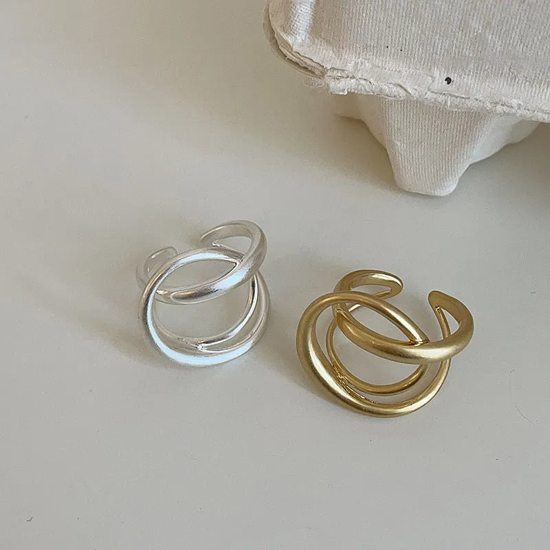 Women's geometric open ring with three-dimensional interlaced matte metal design in gold or silver with real gold electroplating