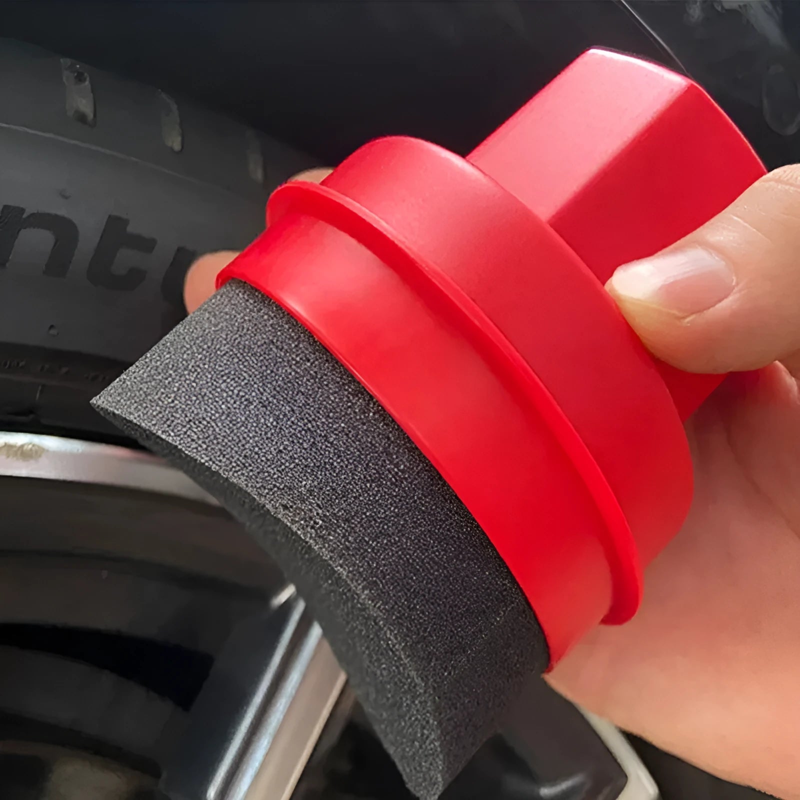 Hand-held black car tyre polishing sponge brush with a lid, showing its compact size and sponge head.
