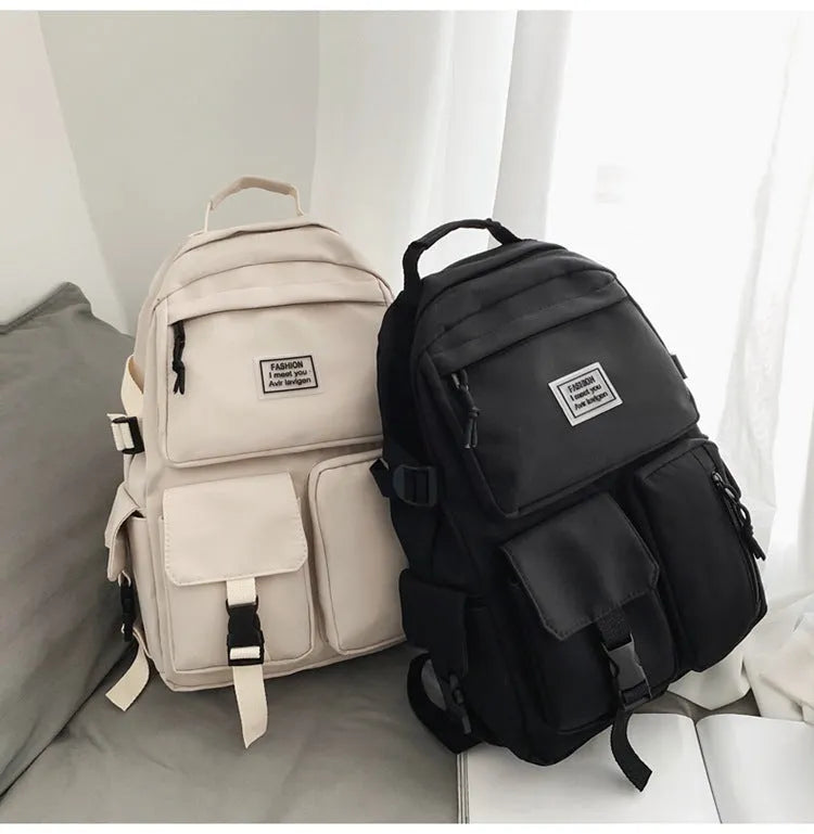 Nylon student backpack in black colour showing laptop compartment and three-dimensional pockets