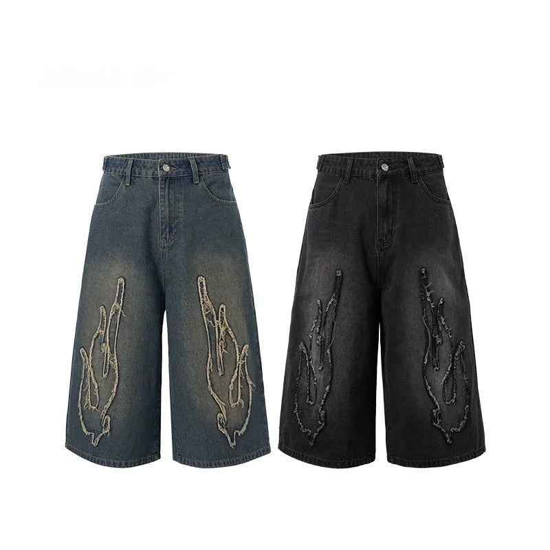 Men's black denim shorts with red flame embroidery patch on leg