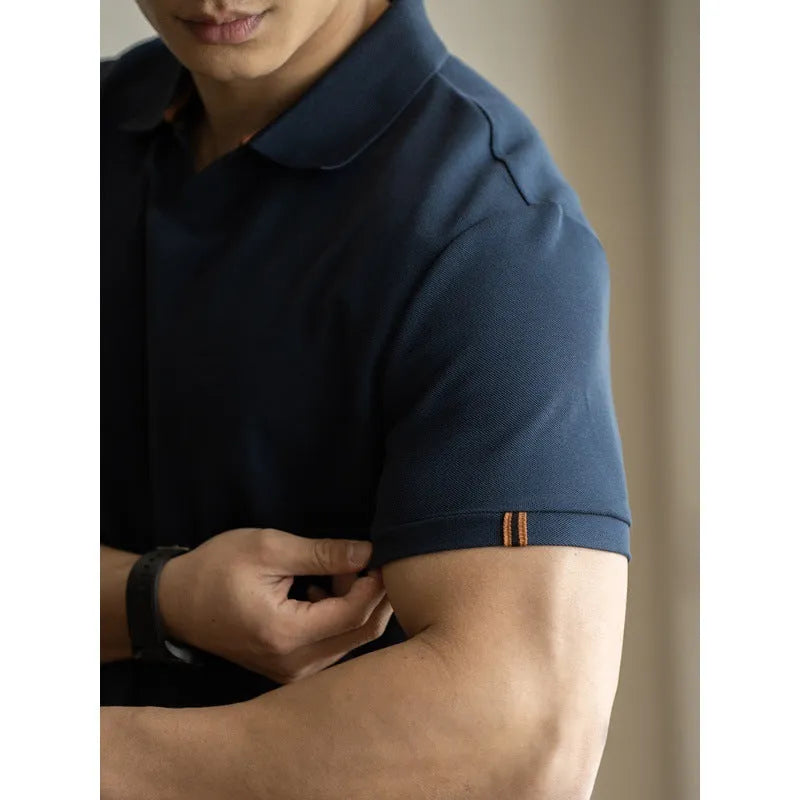 American-style short-sleeved polo shirt in blue on hanger showing regular fit and cotton blend fabric.