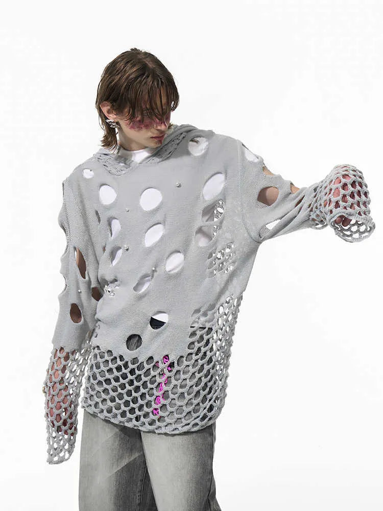 Black men's hollow knit hoodie with pearl decoration on the hood, showing loose fit.