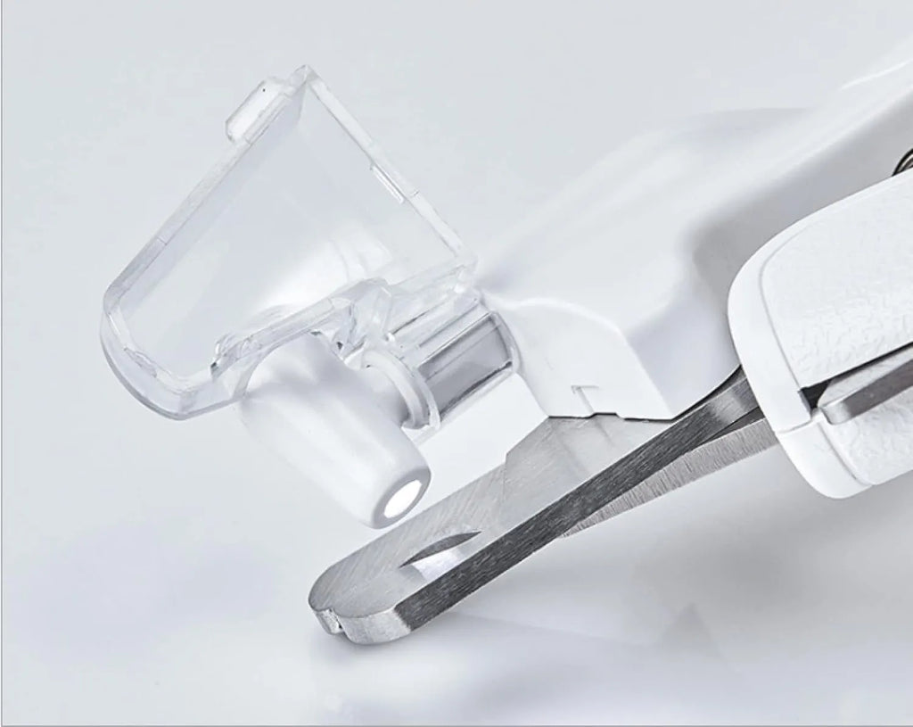 White LED pet nail clippers for cats and dogs with open transparent safety guard and nail file.