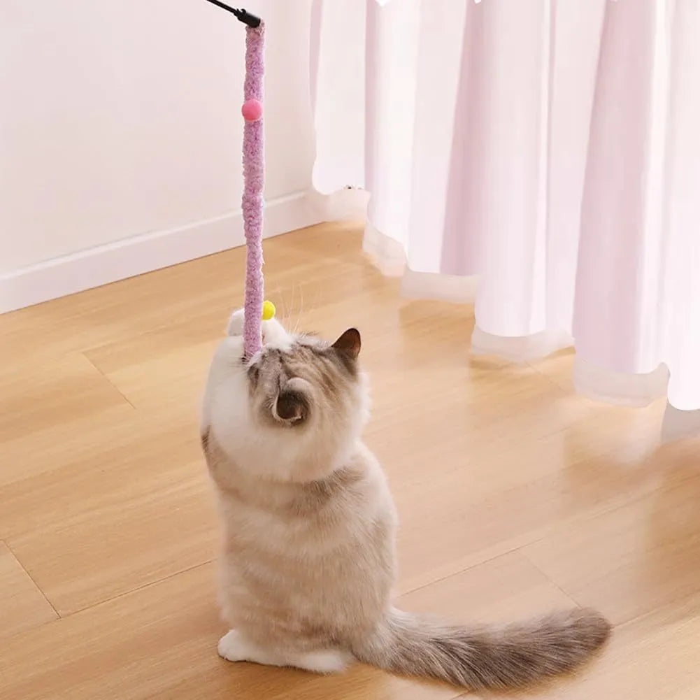 Blue cat wand toy with long plush strip and colourful feather balls attached, held upright.