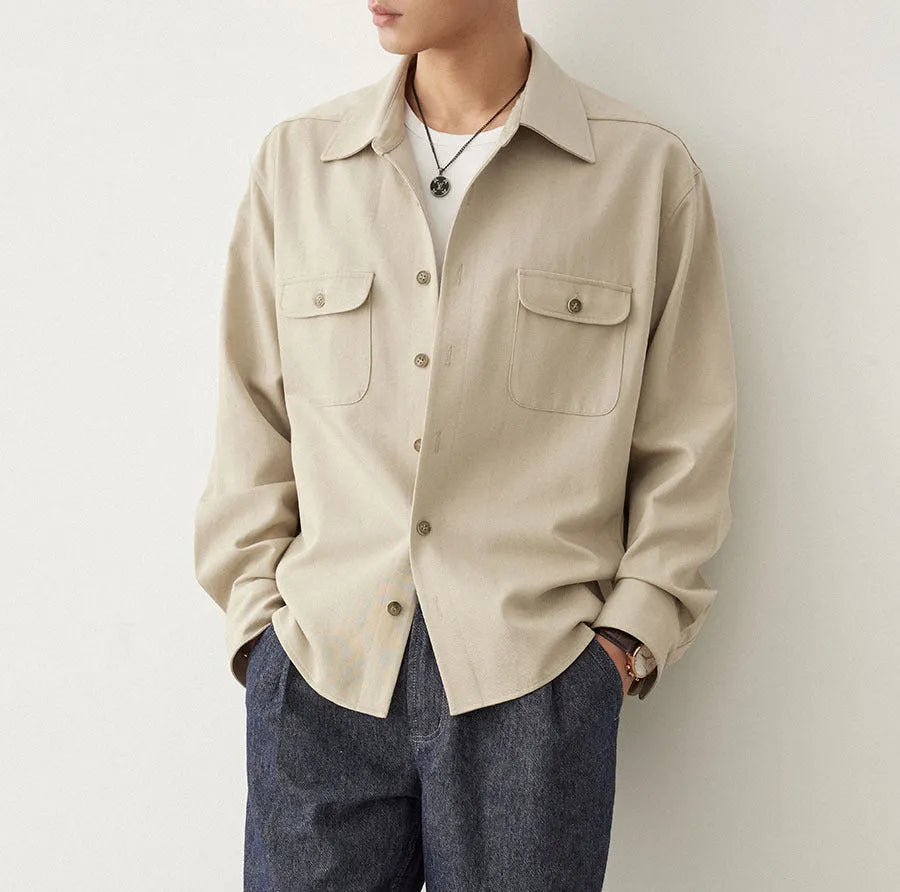 Men's light sand rice coloured long sleeve shirt with a simple lapel collar on a hanger.