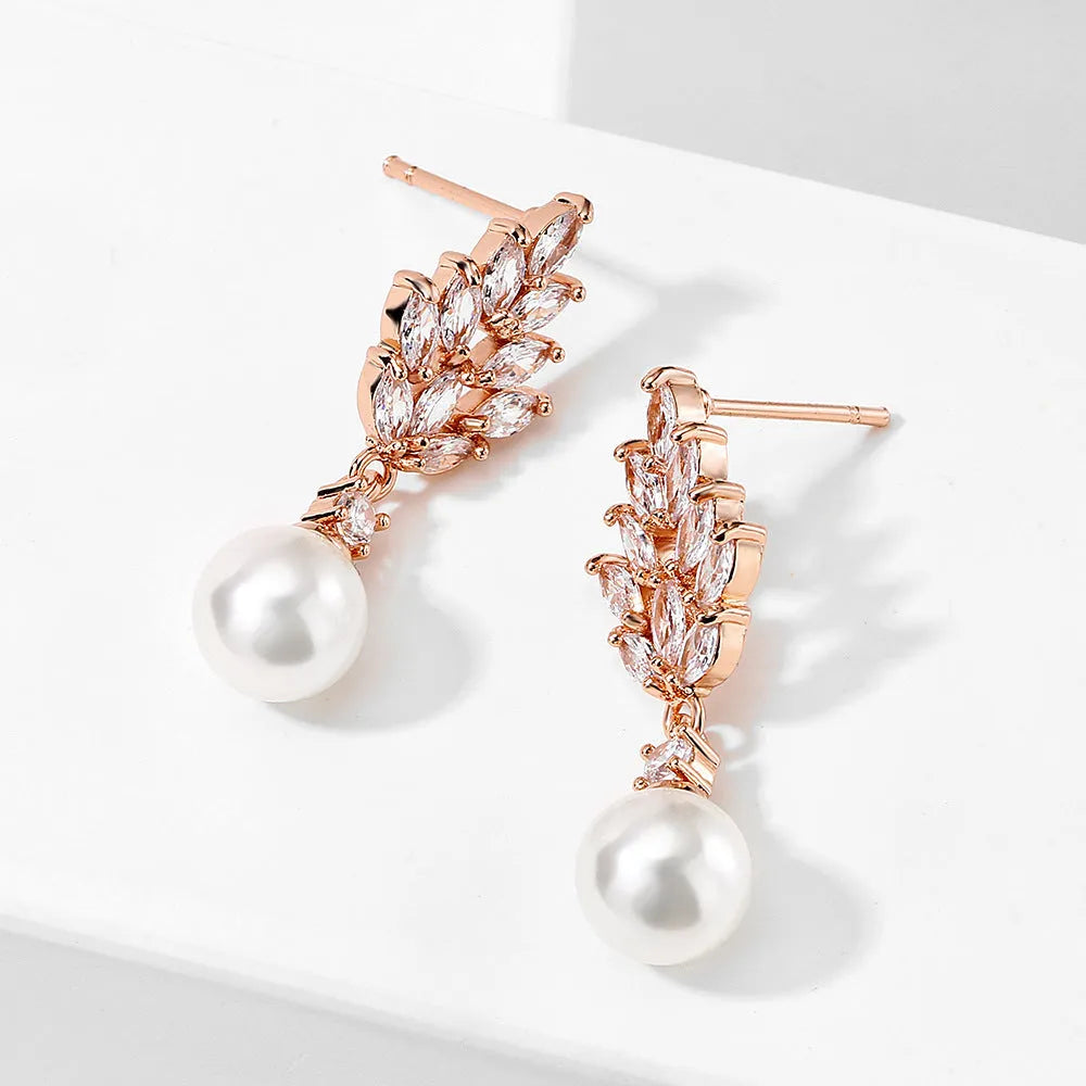 Geometric flower-shaped earrings with micro-inlaid zircon stones and pearl accents in gold, platinum, or rose gold plating.