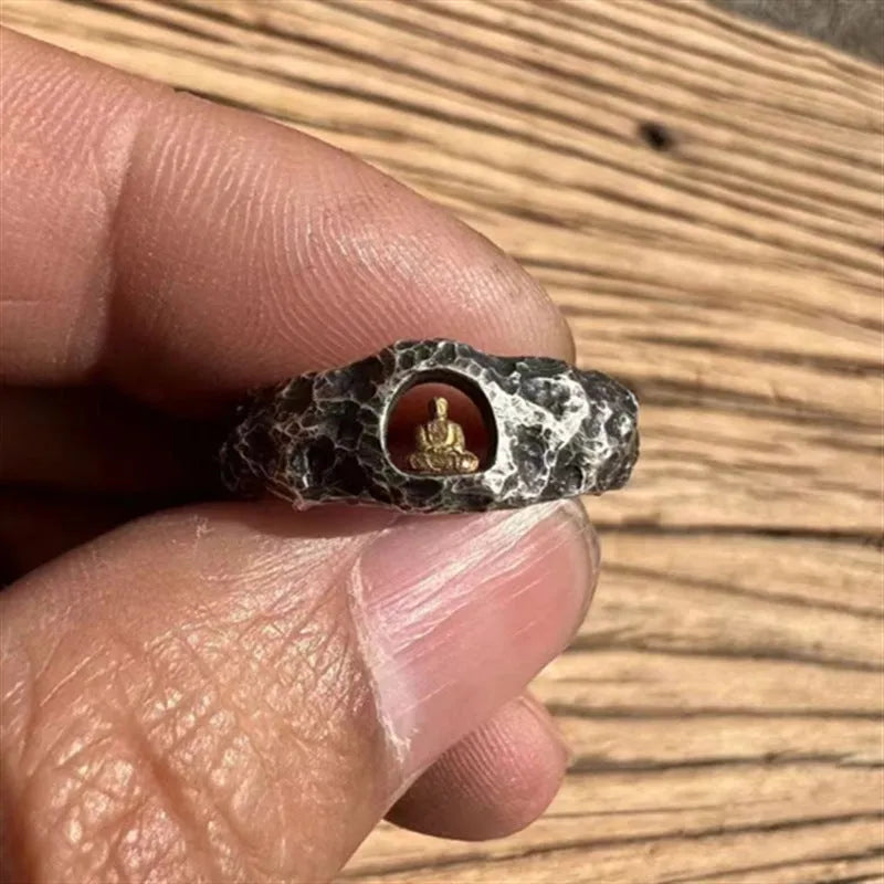 Close-up of a hand-forged copper Buddha ring with a grotto rock texture.