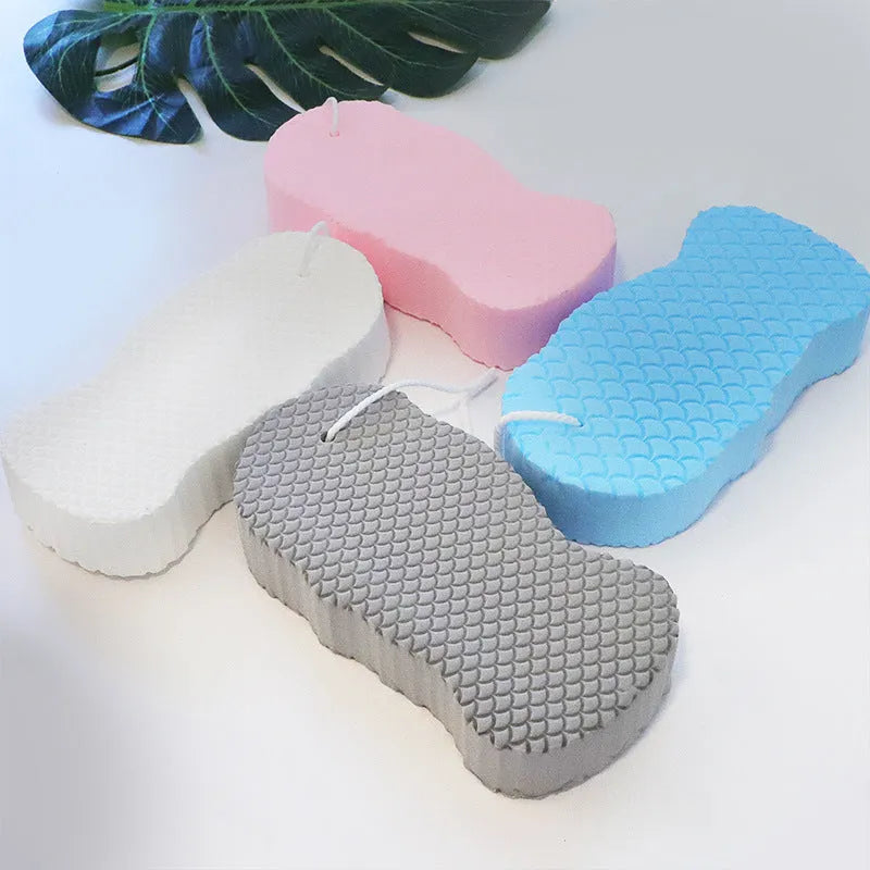 White bath sponge with fish scale pattern and hanging loop for bathroom exfoliation
