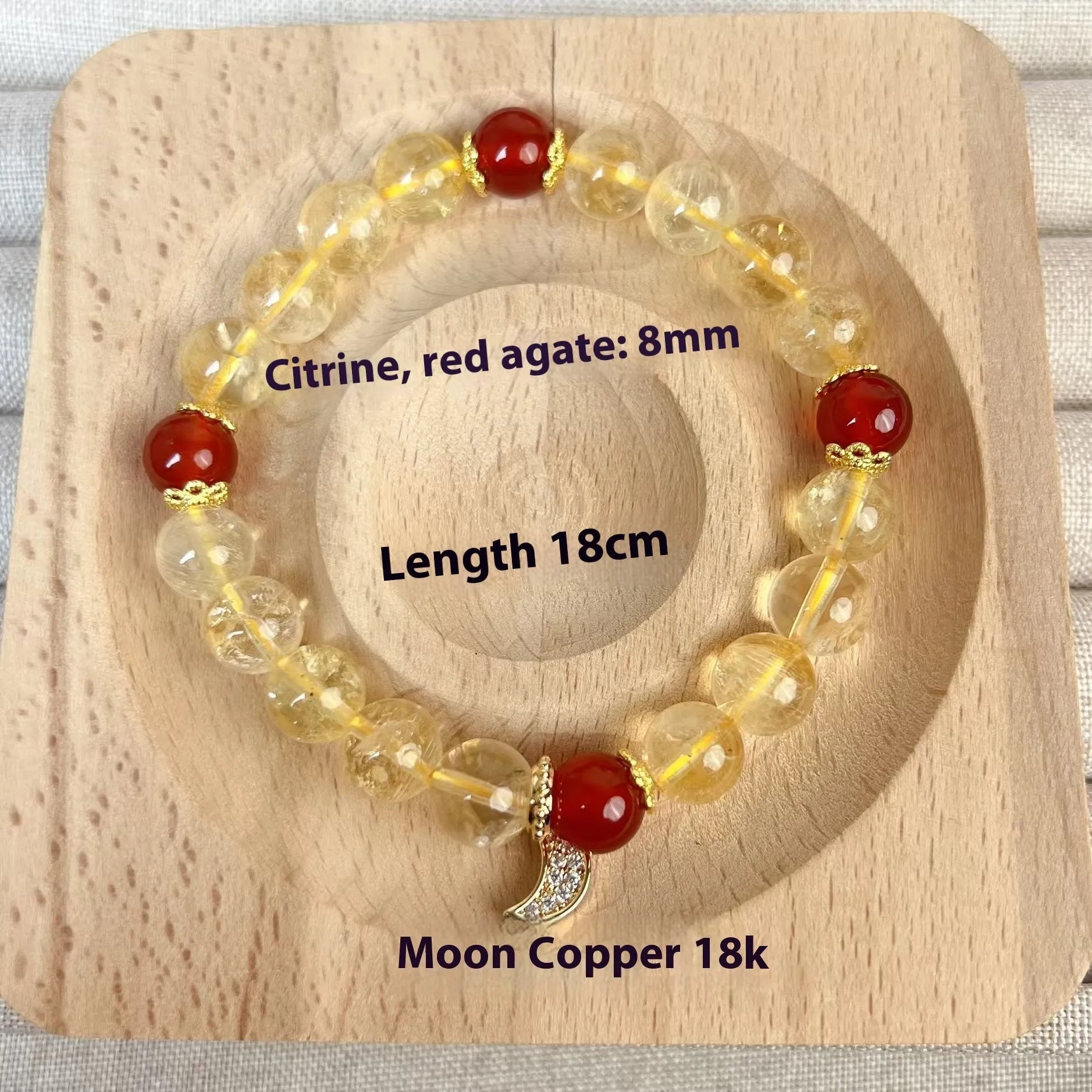 Women's crystal boom bracelet featuring citrine stone, red agate, and central moon design