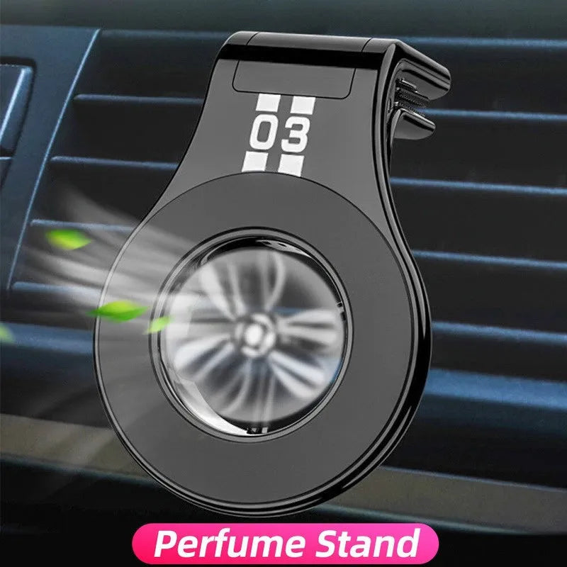 Black magnetic car phone holder with perfume slices, clipped on a car air vent