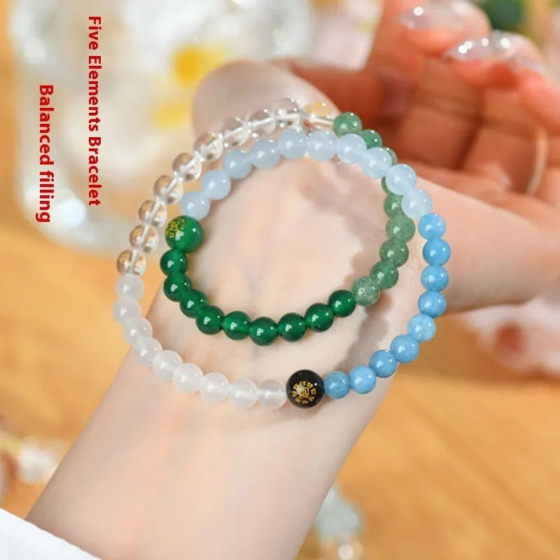 Handmade double ring crystal bracelet in five elements colours on a wrist.