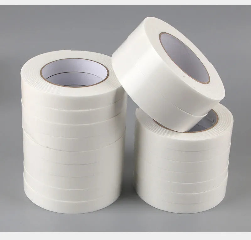 Roll of white foam double-sided adhesive tape showing its thickness, with size options 15mm, 18mm, and 30mm wide.