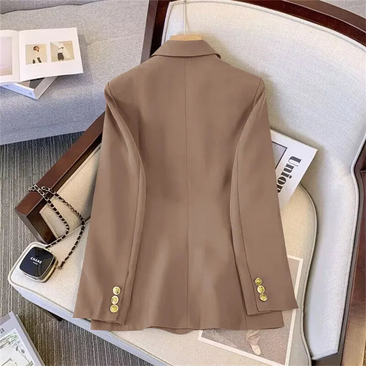 Women's loose-fit polyester blouse and trouser set in beige, shown on a hanger